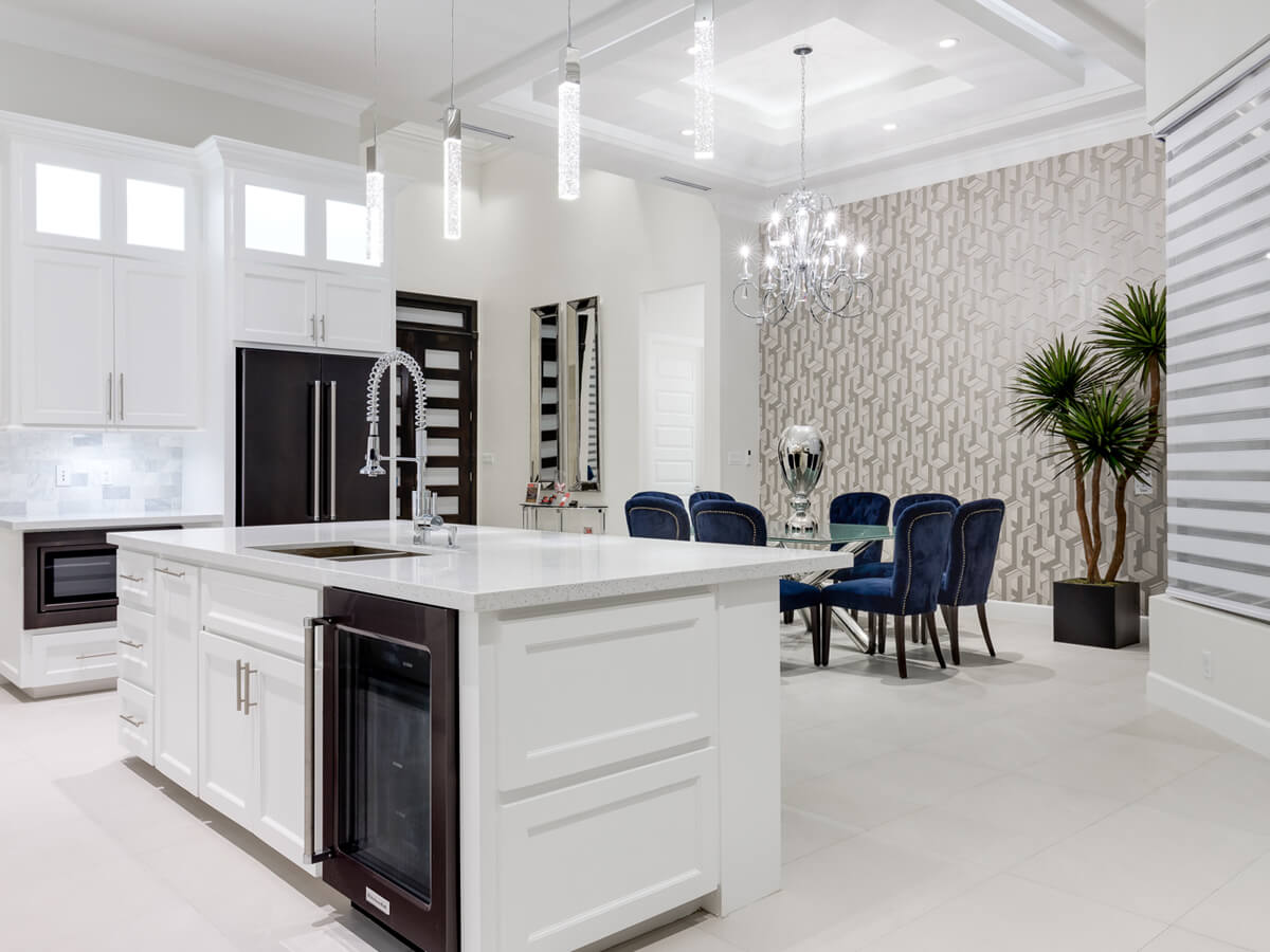 View of a custom built white kitchen and living room, designed by Dolcan Homes 