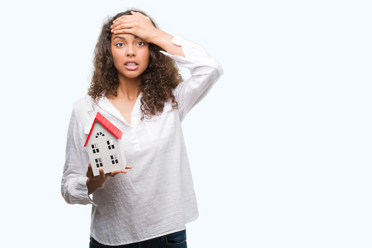 Young hispanic real state agent woman holding small house stressed with hand on head