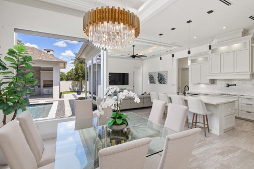 Contemporary kitchen and dining space showcasing a beautiful chandelier as a focal point above the table.